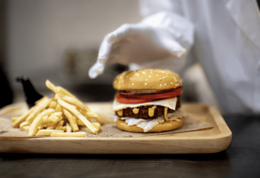 In addition to our commitment to the alternative protein and plant-based space, ADM looks forward to supporting the future of this field Product developer preparing a burger and fries Shanghai 5285 e1649791840526