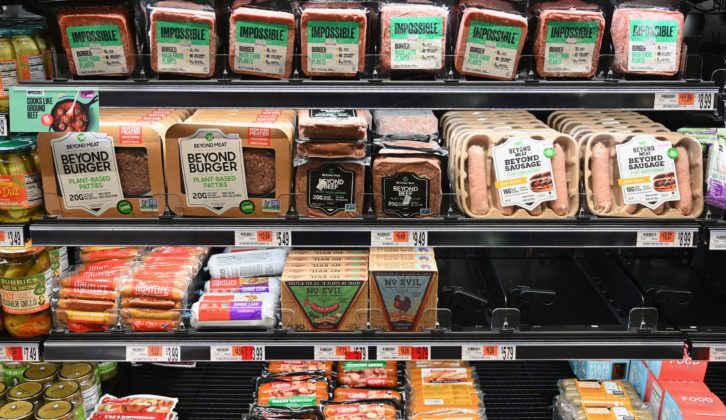 Packages of "Impossible Burger" and Beyond Meat sit on a shelf for sale on November 15, 2019 in New York City. - Vegetarian alternatives to burgers and sausages, revived by start-ups like Beyond Meat and Impossible Burger, are enjoying a certain enthusiasm that meat giants also want to enjoy. Since this summer, the world leader in the JBS sector has been marketing a soy burger in Brazil that includes beetroot, garlic and onions, with a look similar to a rare minced steak. In the US, the largest meat producer Tyson Foods launched a new line of products in June based on plants or mixing meat and vegetables. Its competitors Hormel Foods, Perdue Farms or Smithfield, have similar initiatives. (Photo by Angela Weiss / AFP) (Photo by ANGELA WEISS/AFP via Getty Images)